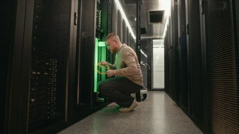 Hardware Engineer Inspecting Wiring System in Server Room Stock Footage 311308526