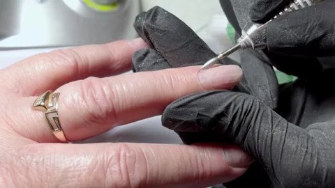 Hardware manicure close up the nail plate is treated with a bit Stock Footage 325046751