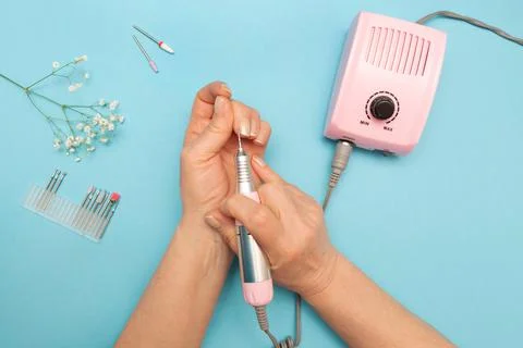 Hardware manicure. Elderly hands. Flat layout. Color background. Nozzles for Stock Photos