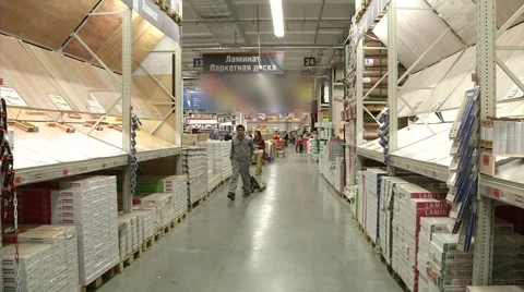 In the hardware store among racks - worker with cart Stock Footage 44219800