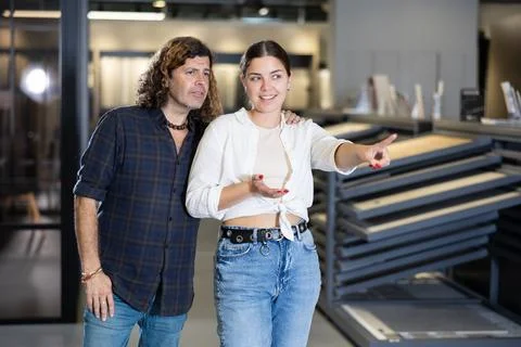 Hardware store employee showing client around materials section Stock Photos