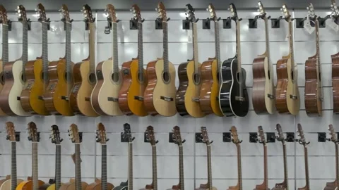 Hardware store; guitar shop; A lot of guitars; guitar on the shelf; Luxury g Stock Footage 229188317