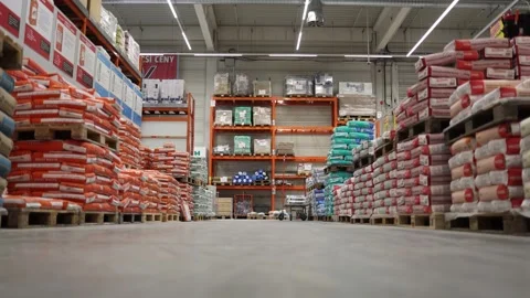 Hardware store warehouse construction materials cement bags stacked pallets indu Stock Footage 307142899