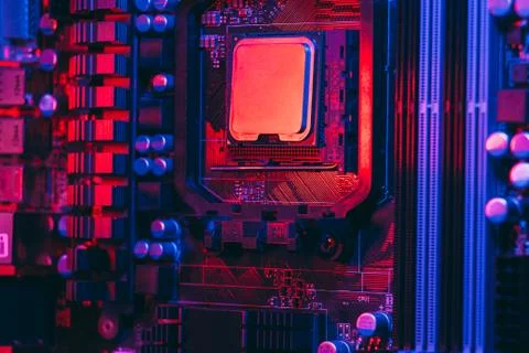 Hardware technology concept in neon light. Motherboard in blue-red light. Com Stock Photos