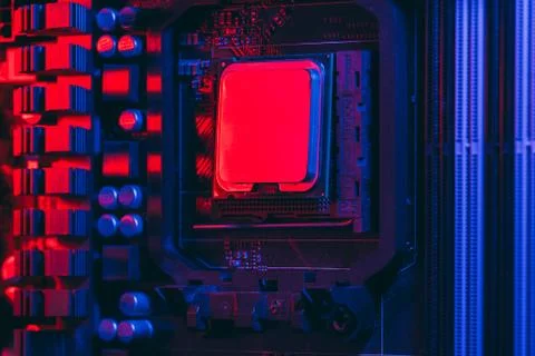 Hardware technology concept in neon light. Motherboard in blue-red light. Com Stock Photos