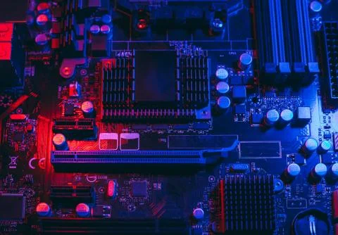 Hardware technology concept in neon light. Motherboard in blue-red light. Com Stock Photos