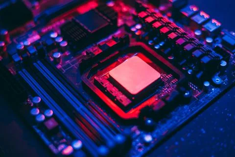 Hardware technology concept in neon light. Motherboard in blue-red light. Com Stock Photos