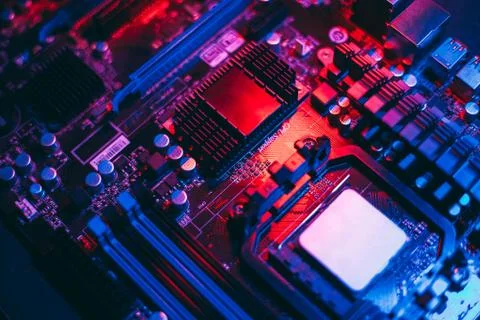 Hardware technology concept in neon light. Motherboard in blue-red light. Com Stock Photos