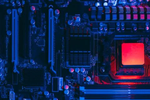 Hardware technology concept in neon light. Motherboard in blue-red light. Com Stock Photos