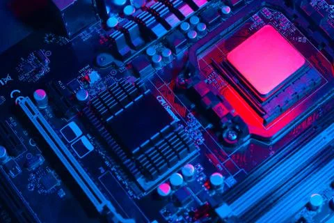 Hardware technology concept in neon light. Motherboard in blue-red light. Com Stock Photos