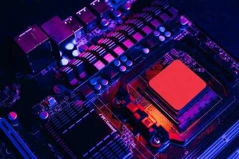 Hardware technology concept in neon light. Motherboard in blue-red light. Com Stock Photos