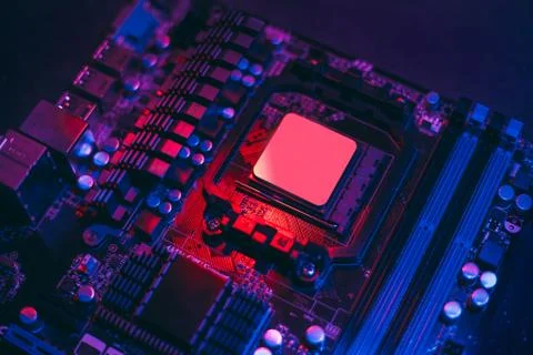 Hardware technology concept in neon light. Motherboard in blue-red light. Com Stock Photos