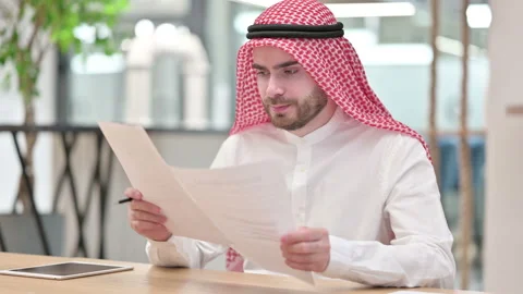 Hardworking Arab Businessman Reading Documents in Office Stock Footage 139422851