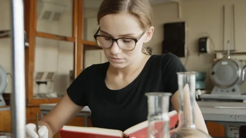 Hardworking caucasian student studies for a class in her chemistry classroom. Stock Footage 113347639
