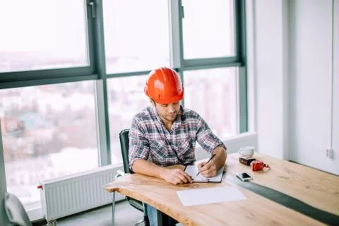 Hardworking cute engineer is making a report Stock Photos