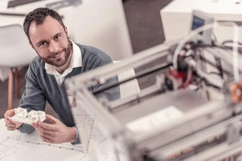 Hardworking engineer creating layouts on 3D printer Stock Photos