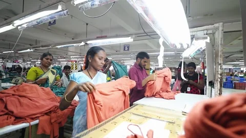 Hardworking indian textile workers folding clothes in slow motion Stock Footage 131153854