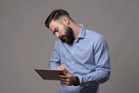Hardworking multitasking busy business man cradling mobile phone on shoulder  Stock Photos