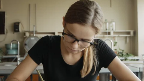 Hardworking student studies for a class in chemistry lab. Caucasian girl in c Stock Footage 113347434