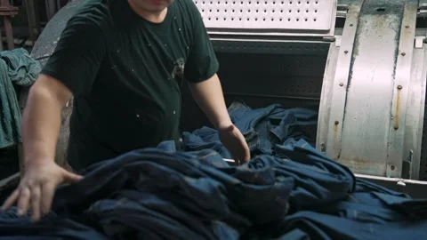 Hardworking Warehouse Laborer Moving Heavy Denim Material Pack Manually Video stock 338372649