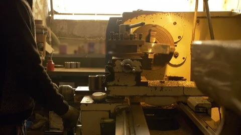 Hardworking worker operating the lathe machine in the plant Stock Footage 120718731
