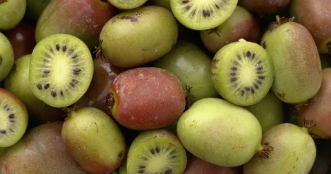 Hardy kiwi fruit (mini kiwi) background. Table spin. Stock Footage 308076151