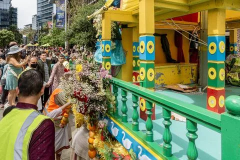 Hare Krishna devotees around a colofully decorated Indian religious float Stock Photos
