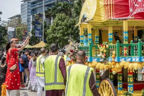 Hare Krishna devotees around a colofully decorated Indian religious float Stock Photos