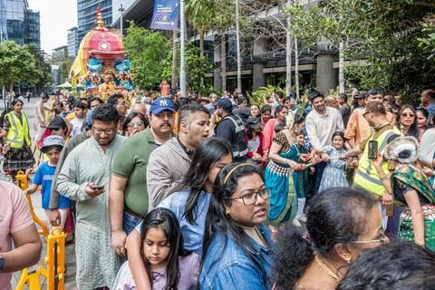Hare Krishna devotees around a colofully decorated Indian religious float Stock Photos