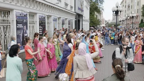 Hare Krishna devotees with hands held high, singing and dancing through Stock Footage 101810870