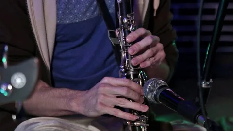 Hare Krishna Man Playing wind instrument clarinet Close-up. Video stock 103985265