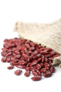 Haricot beans falling out of sack isolated Stock Photos