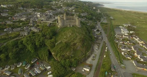 Harlech Castle forward flyover town and rock Stock Footage 90029620