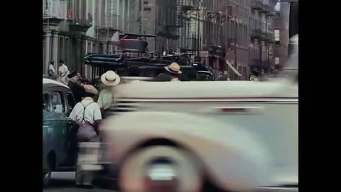 HARLEM - 1930s - A small crowd, including cops, watches firemen pull away in Stock Footage 261573093