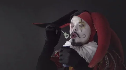 Harlequin making bubbles Stock Footage 127323817