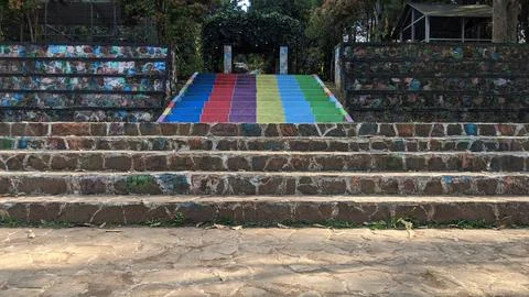 A harmonious combination of stone steps and colorfully painted stairs behind 库存照片