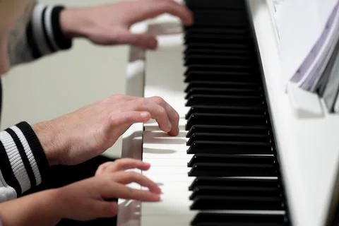 Harmonious hands teach elegant keys during enchanting piano practice Stock Photos