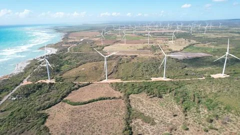 Harmony in Progress: A Beautiful Wind Farm Next to the Serene Beach Stock Photos