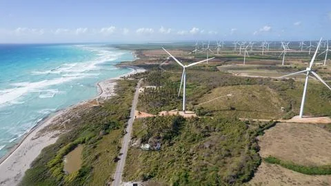 Harmony in Progress: A Beautiful Wind Farm Next to the Serene Beach Stock Photos