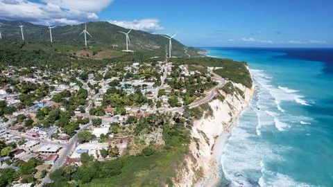 Harmony in Progress: A Beautiful Wind Farm Next to the Serene Beach Stock Photos