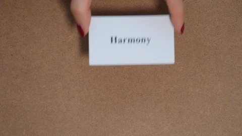 HARMONY. Top shot - Hand puts paper card with word. CORE VALUE concept. 스톡 동영상 124359170