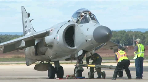 Harrier jumpjet is checked by ground crew during an airshow Stock Footage 57979588