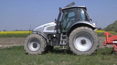 An harrow drawn over soil by a tractor Stock Footage 113296097