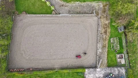 Harrowing the arena for the horses Stock Footage 306763368