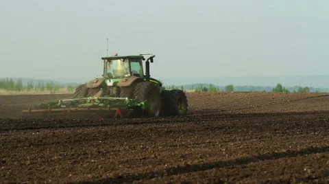 Harrowing the field by using agricultural modern machinary Stock Footage 61459050