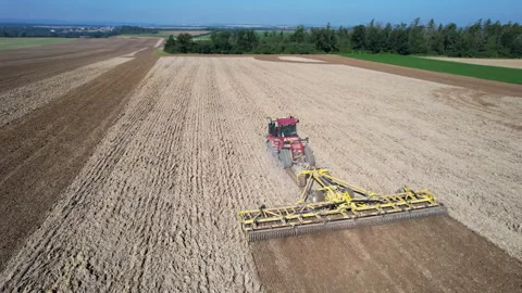 Harrowing a large field with a large crawler tractor. Soil cultivation before Stock Footage 163934674