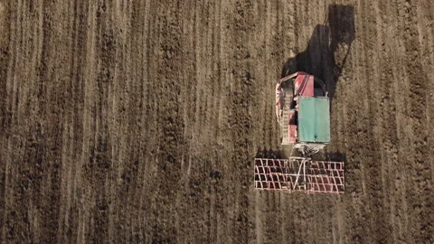 Harrowing the soil with old caterpillar tractor Stock Footage 149245689