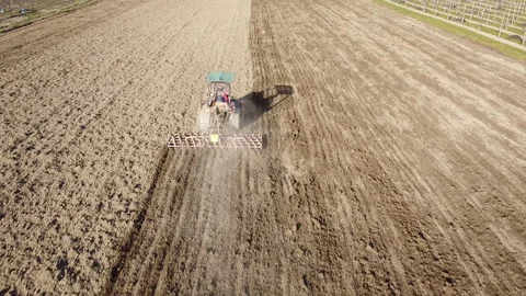 Harrowing the soil with old caterpillar tractor Stock Footage 149249267