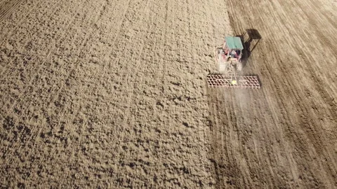 Harrowing the soil with old caterpillar tractor Stock Footage 149266307