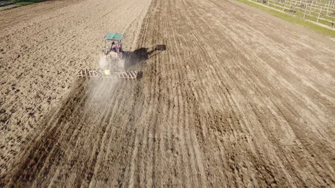 Harrowing the soil with old caterpillar tractor Stock Footage 149381823